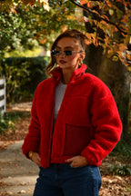 Girl wearing premium thick red winter sherpa jacket. Coat made in the USA.