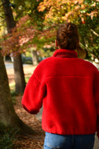 Young woman wearing red winter coat made of premium sherpa. Made in the USA. 